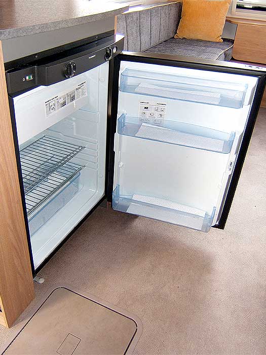 An interior view of the fridge with freezer top box.